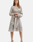 Knee-length floral print dress with a round neckline and long sleeves with button cuffs and removable ribbons.