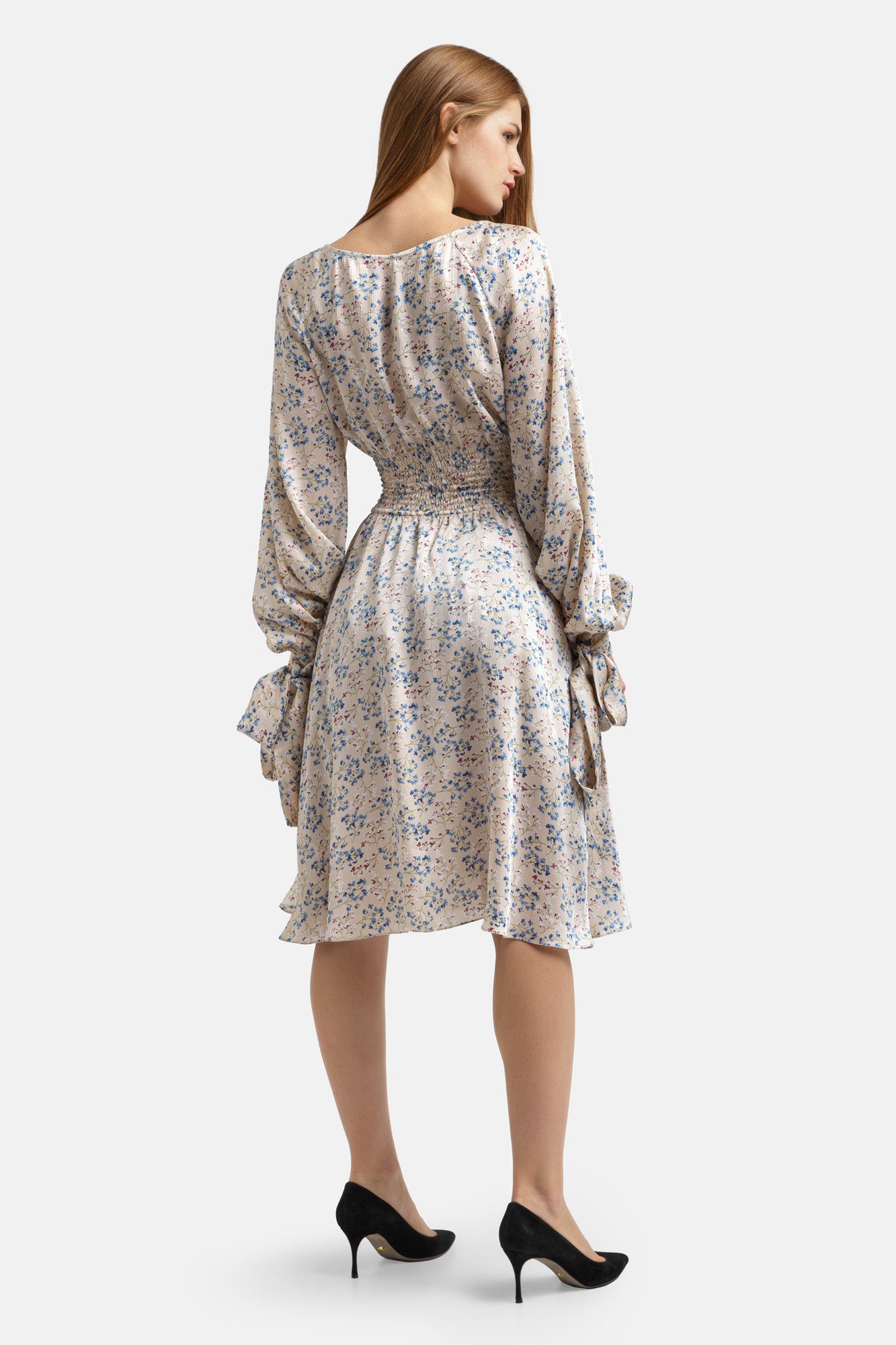 Knee-length floral print dress with a round neckline and long sleeves with button cuffs and removable ribbons.