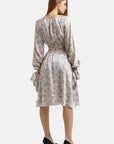 Knee-length floral print dress with a round neckline and long sleeves with button cuffs and removable ribbons.